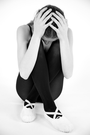 Lonely female teenager holding head desperateの写真素材