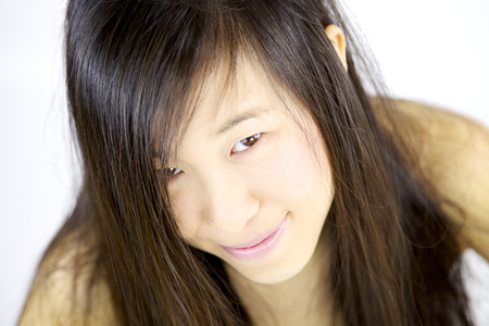 Happy cute smart chinese girl smilingの写真素材