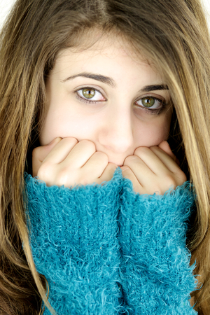 Closeup of beautiful teenager with big green eyes scared