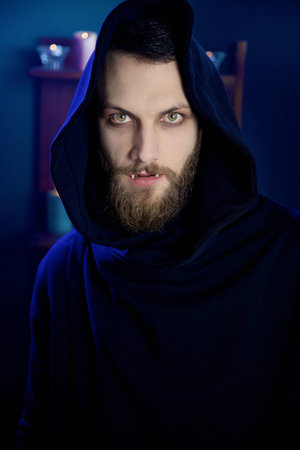 Man vampire with fangs looking camera
