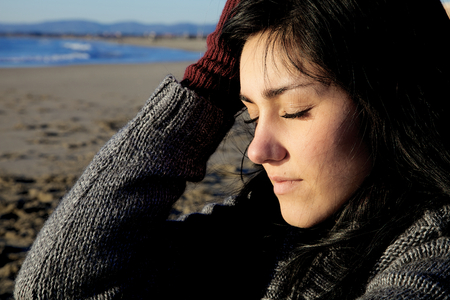 Young woman feeling pain thinking about lost loveの写真素材