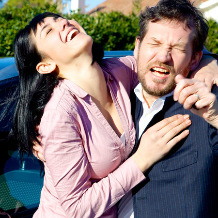 Happy business people laughing outdoorsの写真素材