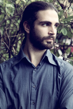 handsome serious hipster  man with beard and long hair