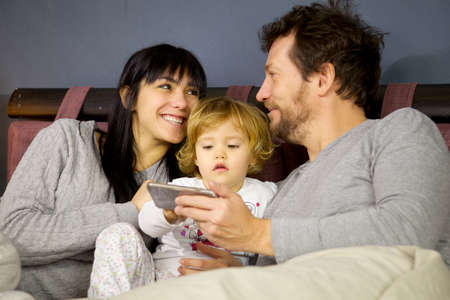 Happy man and woman looking with love daughterの写真素材