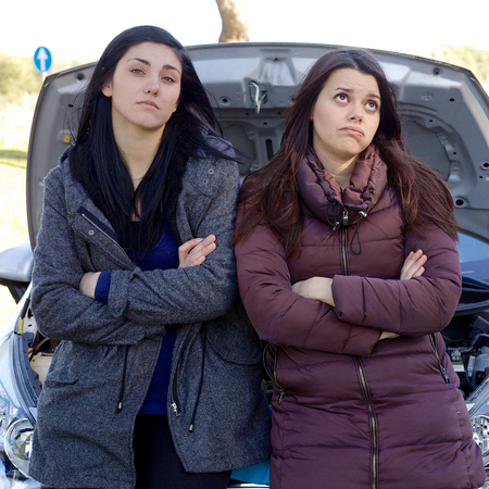Two women sad waiting long time for helpの写真素材