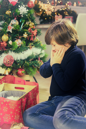 kid surprised about christmas giftの写真素材