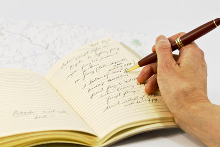 Open journal with travel planning notations and map beneath book