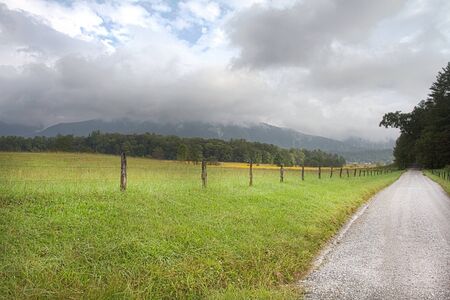 Fence and road of Cades Cove  in Great Smoky Mountains National Park.  Journey evoked by gravel, Appalachian road. の写真素材