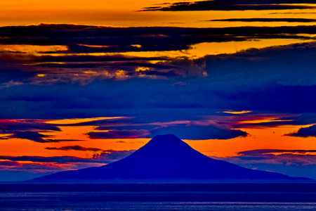 Brilliant colors of sunset view of Augustine volcano viewed from Homer, Alaska, overlook.の写真素材