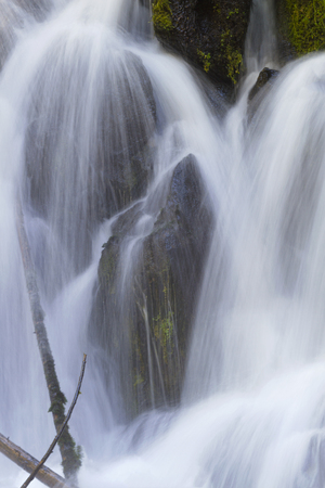 Cascading waterfall over rocks looks like three monks in serene, natural beauty. Location is Clearwater Falls in Oregon on Umpqua Scenic Byway.の写真素材