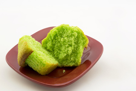 Vibrant green of sliced, fresh pistachio nut muffin.  Specialty baked good on red plate.  Copy space above on horizontal image.の写真素材