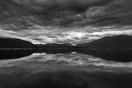 Black and white reflects the gray cloudiness of weather blowing onto Lake Burbury in Tasmania