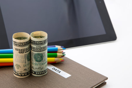 Successful investment is based on research, data, and facts seen in symbols of currency, notebook...