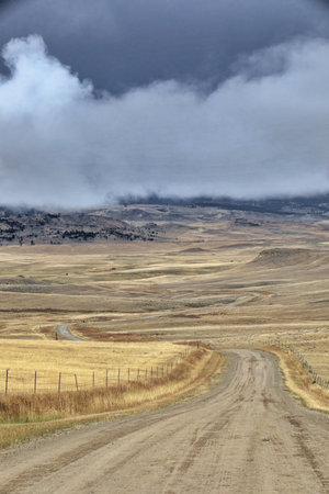 Remote journey down winding, dirt turns of Big Timber Canyon Road in Custer Gallatin National Forest in Montana, United Statesの写真素材