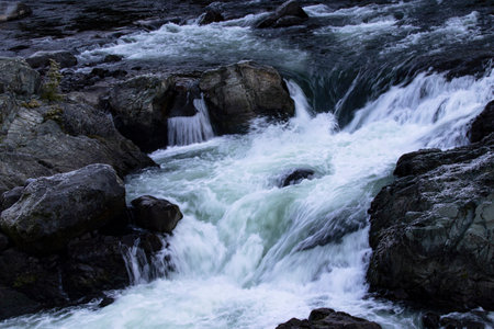 Chance Creek currents spill into a natural, swirling water bowl  along scenic beauty of Sea to Sky Highway, Squamish to Whistler segment, in British Columbia, Canadaの写真素材