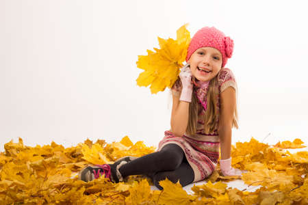 Girl at autumn with yellow leavesの写真素材