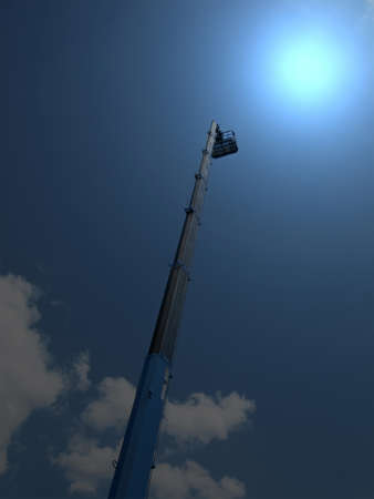 high long industrial crane arm with cradle on dark blue sky with clouds. abstract magic light conceptの写真素材