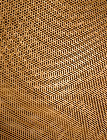 focus on center. abstract gold metal surface with hole heap, industrial background texture closeup
