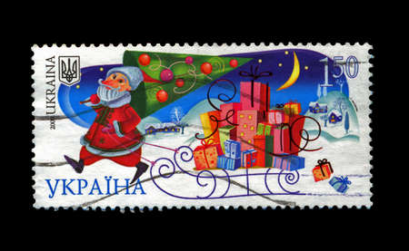 UKRAINE - CIRCA 2008: cancelled stamp printed in UKRAINE, shows russian Santa Claus with pine-tree as folktale person for New Year, circa 2008. Happy New Year 2009 as text.の写真素材