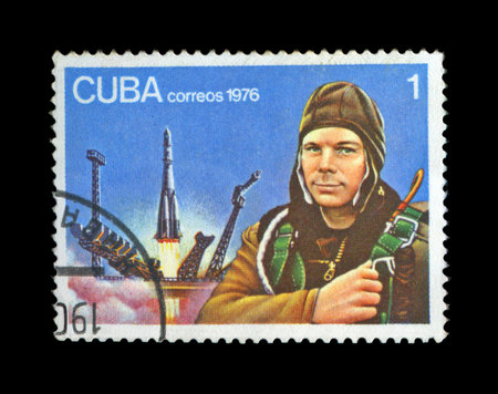CUBA - CIRCA 1976: cancelled stamp printed in CUBA, shows first russian, soviet astronaut Yury Gagarin, space-vehicle launching site, shuttle start, circa 1976. vintage post stamp on black background.のeditorial素材