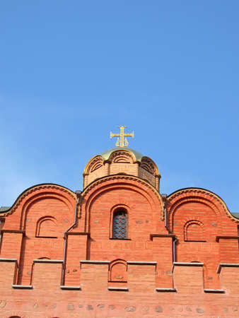 golden gates antique architecture from red brick with religious sign on blue sky, vintage architecture detailsの写真素材