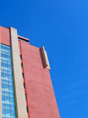 one red brick industrial building on blue sky, construction details