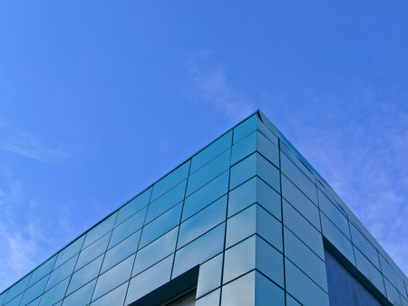 modern green building with many frames on blue sky with white clouds. new construction concept
