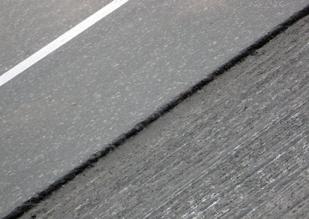 abstract damaged black asphalt with white barier line, road details