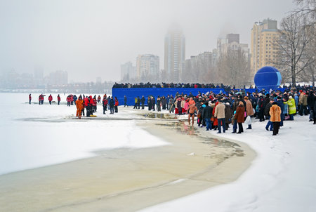 KIEV - JAN 19: Epiphany (Kreshchenya) morning on January 19, 2013 in Kiev, Ukraine. People plunging into ice-cold water three times as it helps body became more resilient to illness. Epiphany known since 988 AD.のeditorial素材