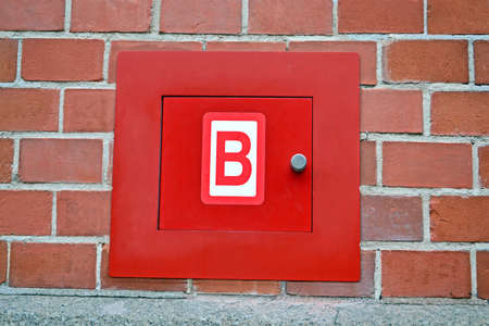 red fire box for hydrant on the red brick wall, modern security detailsの写真素材