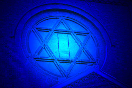 magic blue light over jewish star on vintage church, old stone wall detailsの写真素材