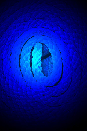 magic blue light over sea cord on wooden surface, round bulk details