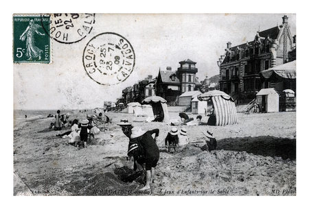 HOULGATE (CALVADOS), FRANCE - CIRCA 1909: vintage postcard printed in France shows kids on the sand beach, circa 1909.のeditorial素材