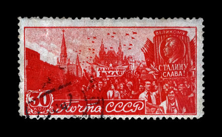 MOSCOW, USSR - CIRCA 1947: canceled stamp printed in USSR shows May Day Parade on Red Square in Moscow, circa 1947. Vintage post stamp isolated on black background.のeditorial素材