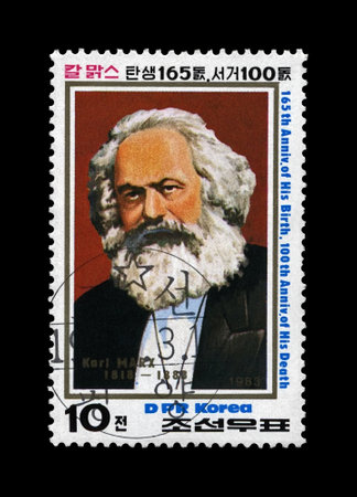 Karl Marx, famous politician leader, Capital - Critique of Political Economy book author, circa 1983., DPR KOREA (NORTH KOREA. canceled postal vintage stamp  isolated on black background.のeditorial素材