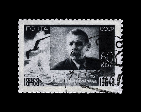 USSR - CIRCA 1943: canceled stamp printed in the USSR (Soviet Union) shows Maxim Gorky aka Alexei Maximovich Peshkov (1868-1936), famous Russian writer, dramatist, politician, circa 1943. vintage postal stamp isolated on black background.のeditorial素材