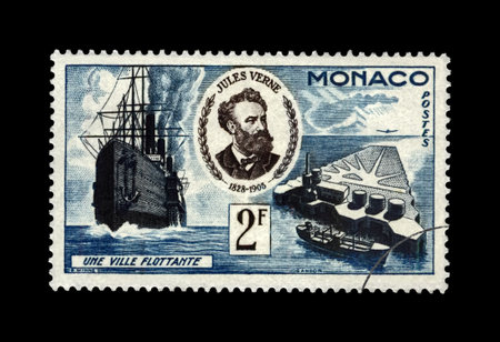 Jules Verne, famous science writer and Floating City, Monaco, circa 1955.  Canceled vintage postal stamp isolated on black background.のeditorial素材