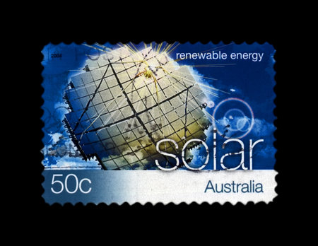 AUSTRALIA - CIRCA 2004: canceled stamp printed in Australia shows solar power station on blue sky with clouds, solar renewable energy, circa 2004. vintage postal stamp isolated on black background.のeditorial素材