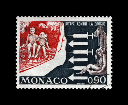 Campaign against drugs addiction among youth, fight against junkie issue, circa 1973. vintage canceled postal stamp printed in Monaco isolated on black background.のeditorial素材