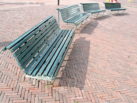 few metallic street bench on red bric, travel diversity