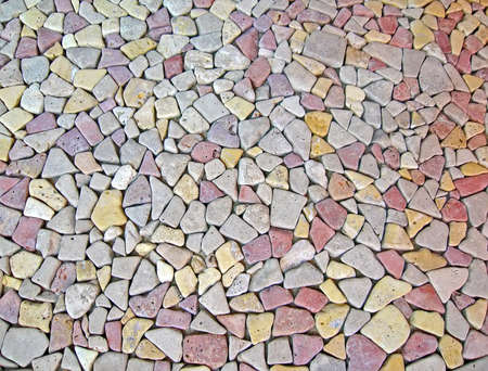 different color stone wall background, small stones heap diversityの写真素材