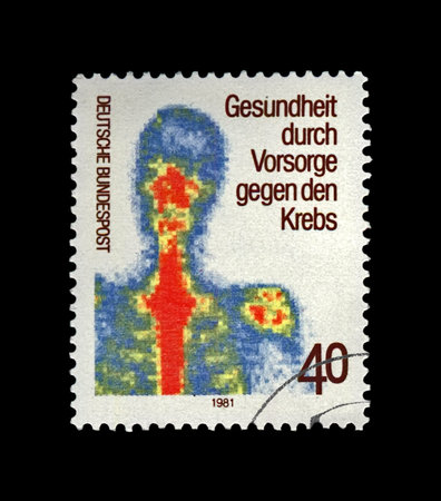 early cancer detection (examination for the prevention of human illness), circa 1981. vintage canceled post stamp printed in Germany isolated on black background.のeditorial素材