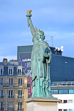 PARIS, FRANCE - DEC 31, 2017: The Statue of Liberty replica on Isle of the Swans near Pont de Grenelle on December 31, 2017 in Paris, France. Monument has 22 metres tall.のeditorial素材