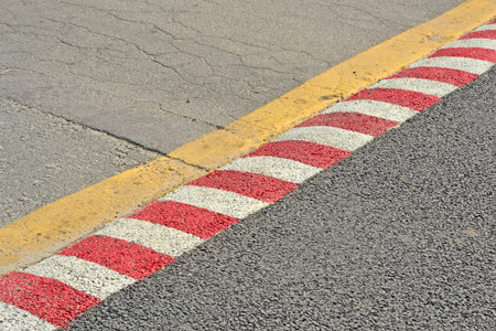 focus on center striped line. red barrier line on asphalt, security area diversityの写真素材