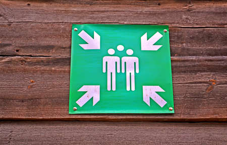 people communication area with whirte arrows as green sugn on wooden surface, area diversityの写真素材