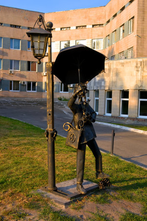 KIEV, UKRAINE - AUG 30, 2019: forged curly metal men statue with umbrella in the Kyiv City Psychiatric Hospital N1 named after Pavlov I.P. (formerly Kirillovskaya clinic) on August 30, 2019 in Kiev, Ukraine. The psychiatric institution was found in 1786. のeditorial素材