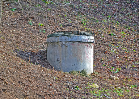 abandoned vintage concrete cylinder bunker, sewage manhole diversity