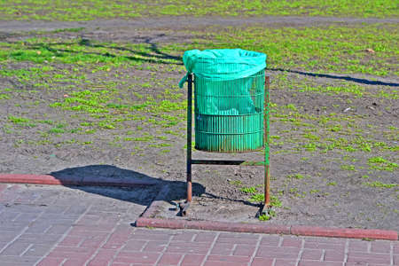 green trash bin closeup in sunny day, clear environment diversityの写真素材