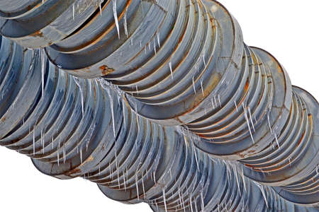 large metal welding pipe with icicles and many rings isolated on white background, vintage weld heating system diversityの写真素材