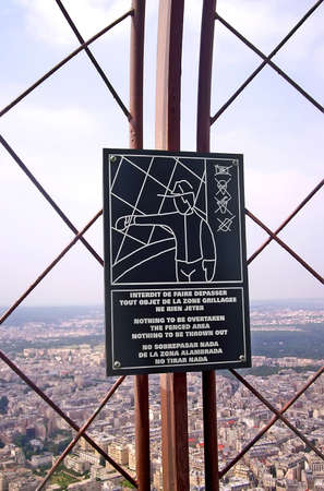 garbage refuse prohibited as warning message, metallic black block signboard with human silhouette on metal grid closeup, sanitary environment diversityの写真素材